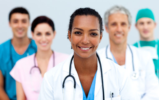 Attractive female Doctor standing before her team